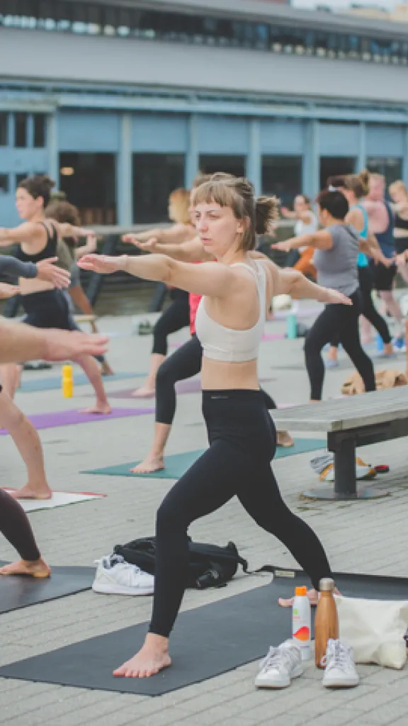 Citizens and yoga lovers alike enjoy a peaceful Yoga and Pilates lesson in front of the Delaware River.