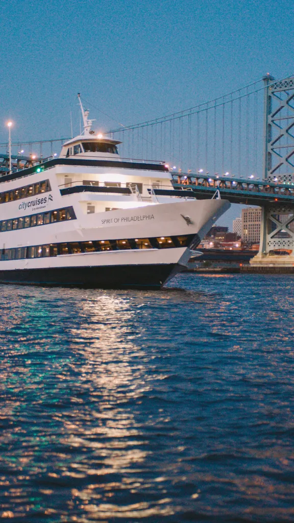 Yacht sailing under the Ben Franklin bridge