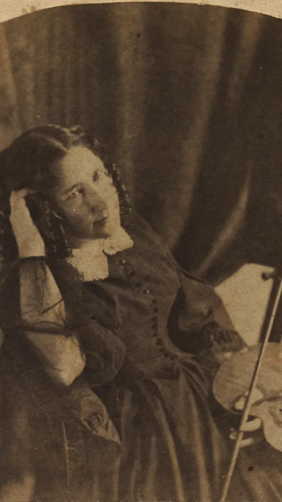 Black and white image of Mary Jane Peale seated and holding her painter's palette in her left hand.  Her right rests on the back of her chair and holds the side of her head.  