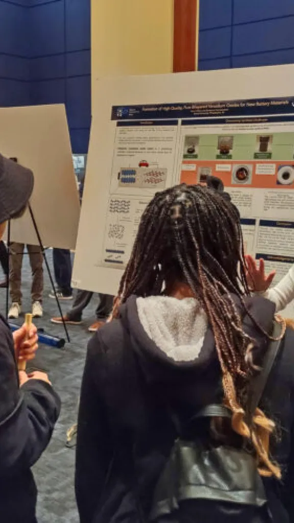 people talking in front of a poster