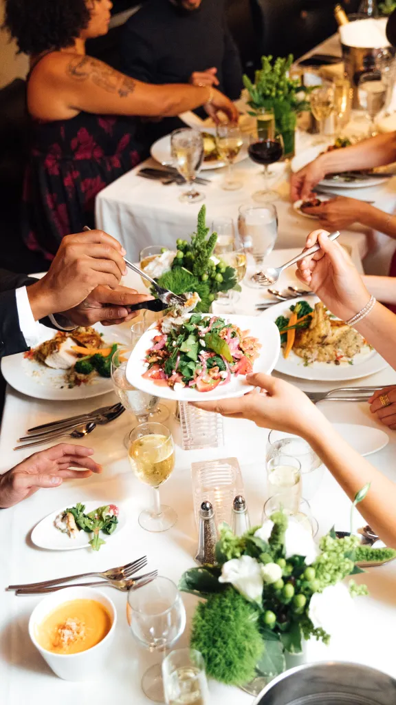 Group of people eating at table.