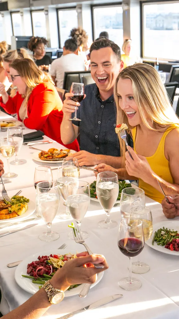 Group of people eating around table.