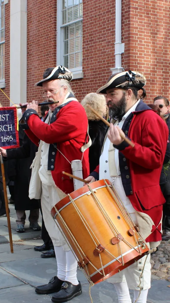 Citizens in period costumes playing music to start the procession to Franklin's grave