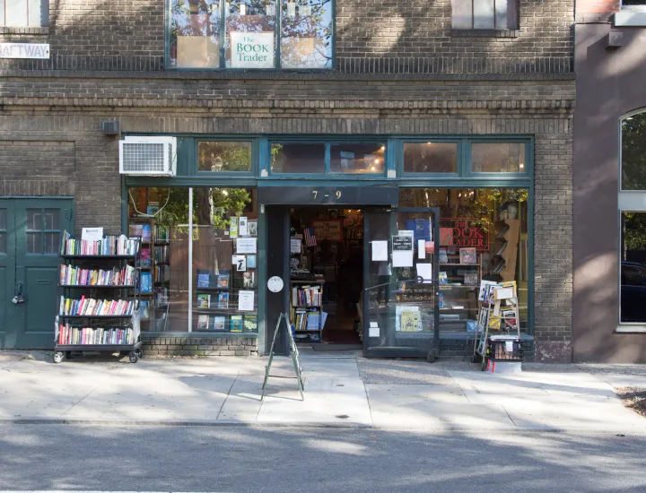 Exterior photo of The Book Trader shop on N. 2nd Street in Old City, Philadelphia with books on display outside and in front windows