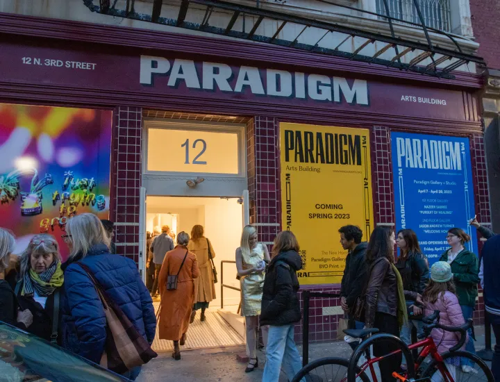 External photo of Paradigm Gallery with attendees entering 