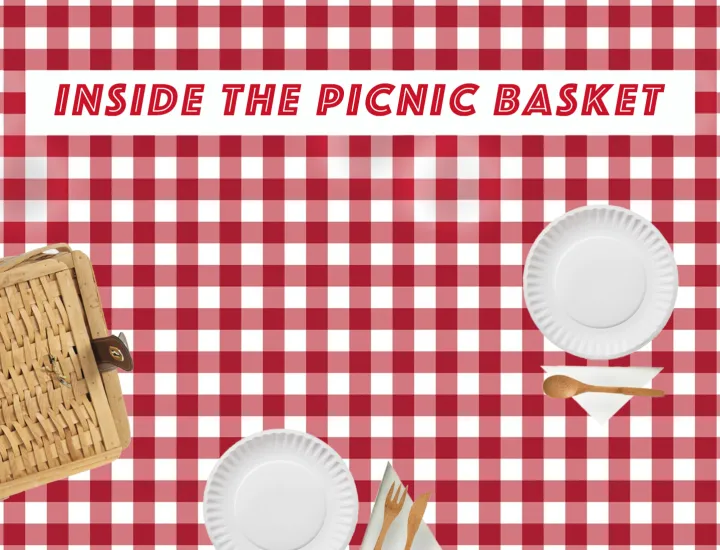 The photo is of a picnic blanket with paper plates, bamboo napkins, and a picnic basket, sprawled out. The title of the exhibition, "Inside the Picnic Basket", is inside a white box at the top. 