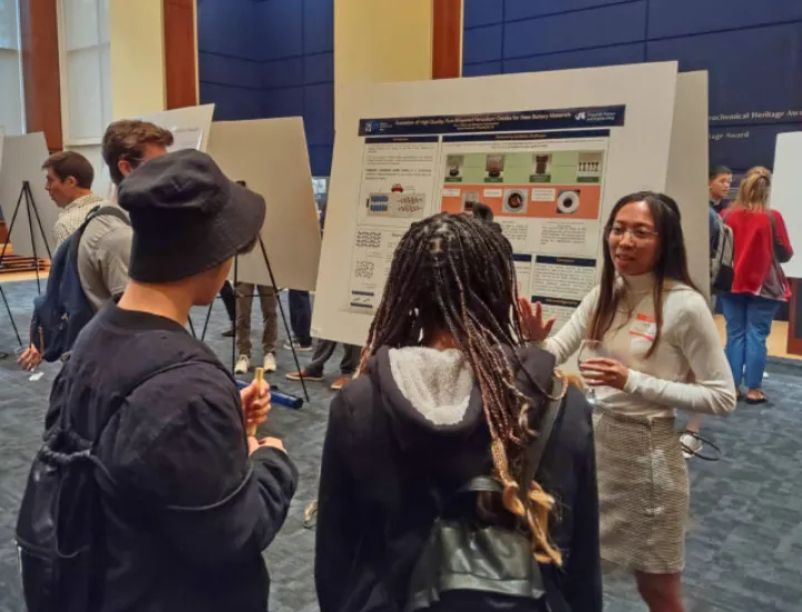 people talking in front of a poster