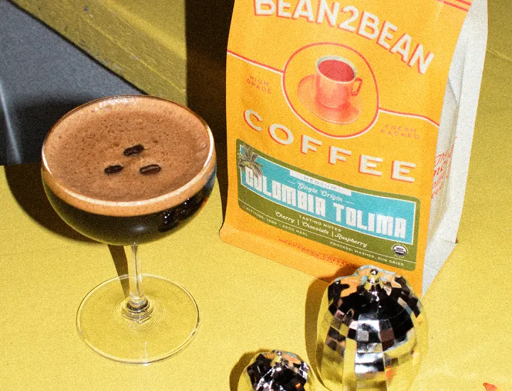 A coffee cocktail on the Sunday Girl bar with mirror ball pumpkins and a Bean2Bean bag of coffee.