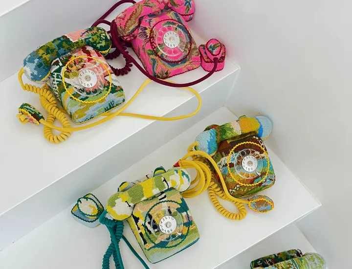 Photo of embroidery -covered desktop rotary telephones