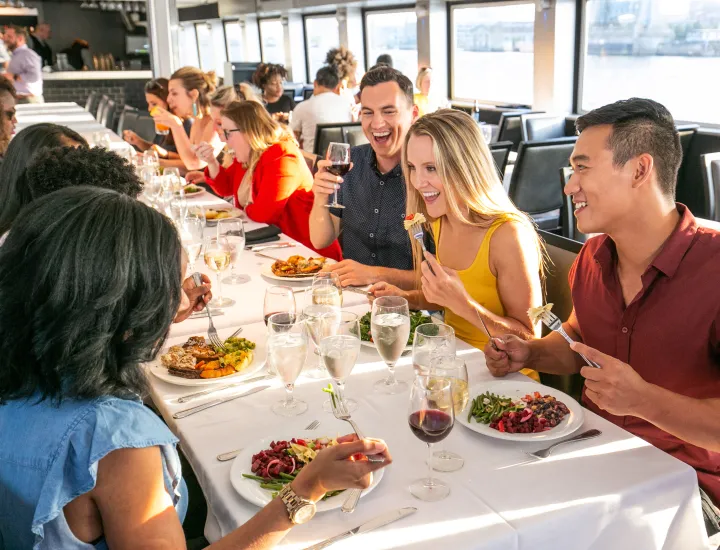 Group of people eating around table.