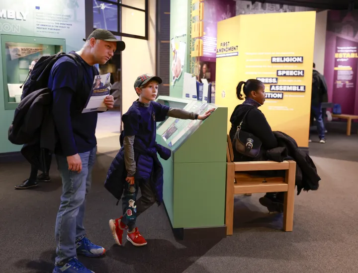 man and boy standing in first amendment gallery