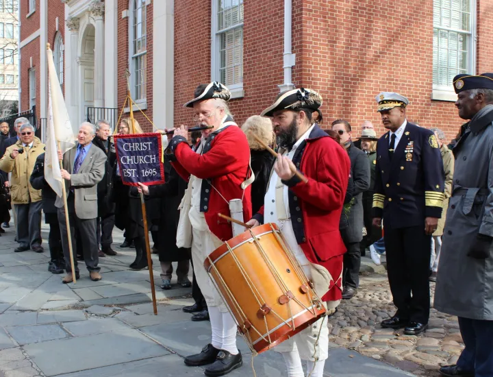 Citizens in period costumes playing music to start the procession to Franklin's grave