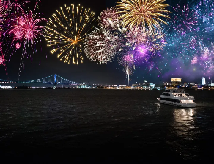 Vessel with bridge and fireworks in background.